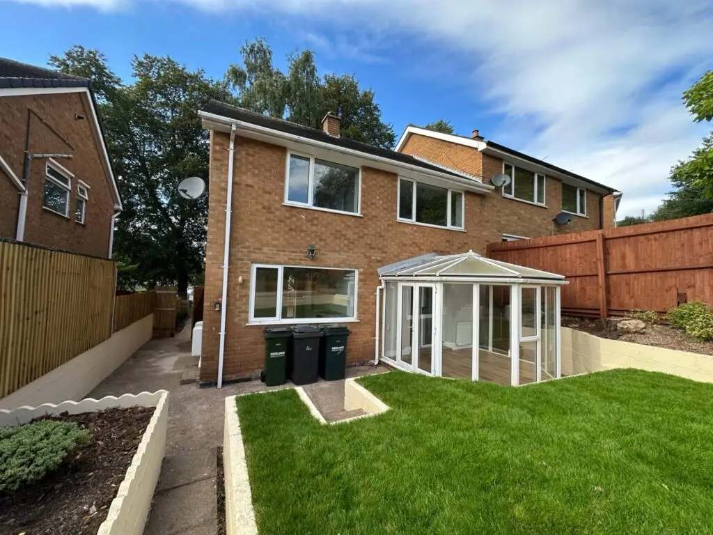 The same Gedling property after a full refurbishment, with a new lawn, planting, painted walls and new fencing