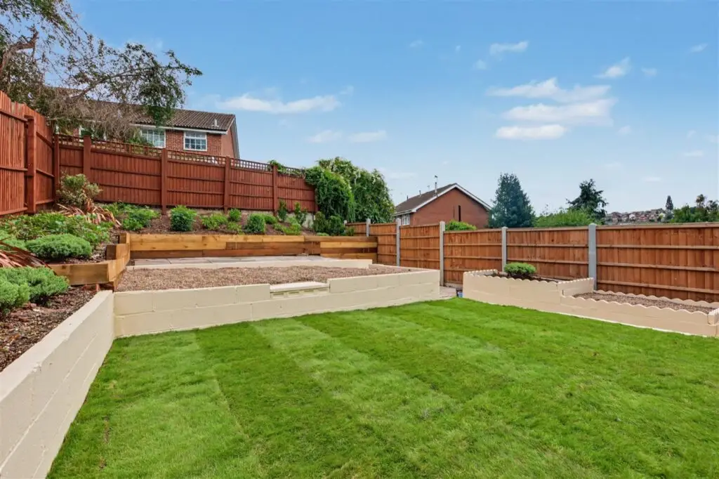Landscaped back garden with new lawn, rebuilt raised beds and new fencing