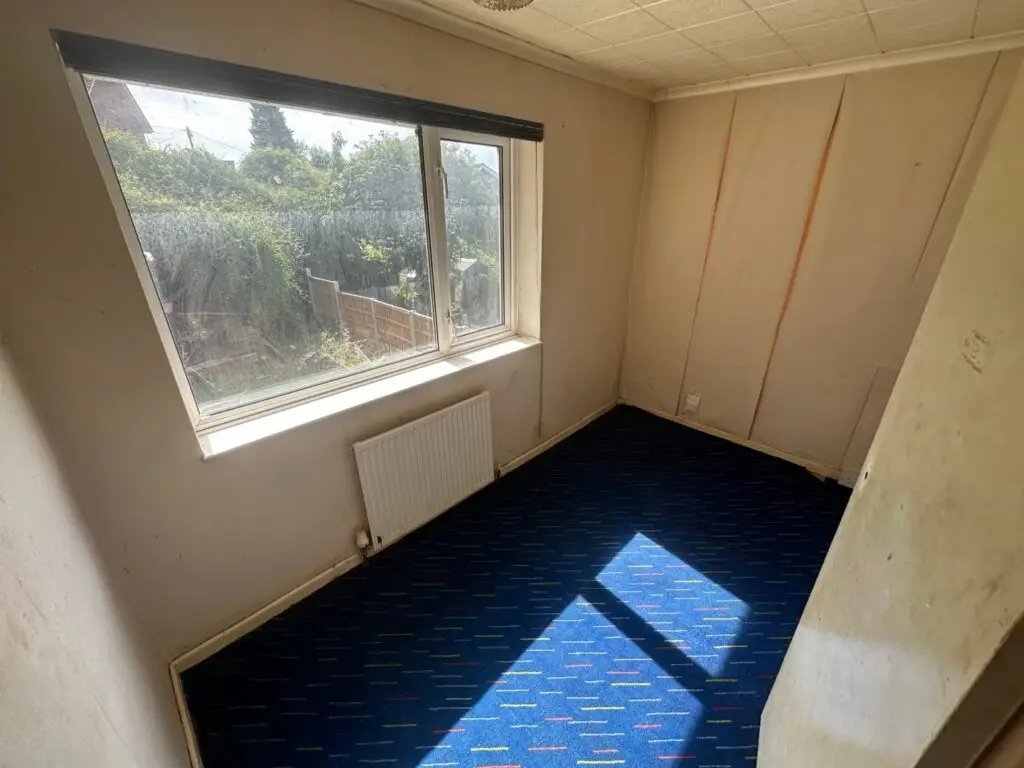 Third bedroom with old wall panelling, ceiling tiles and patterned carpet before the refurbishment