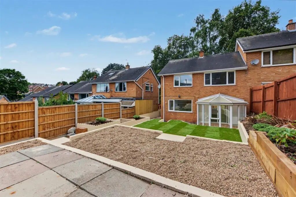 Rear of the refurbished Gedling house with conservatory, new lawn, gravel and fencing